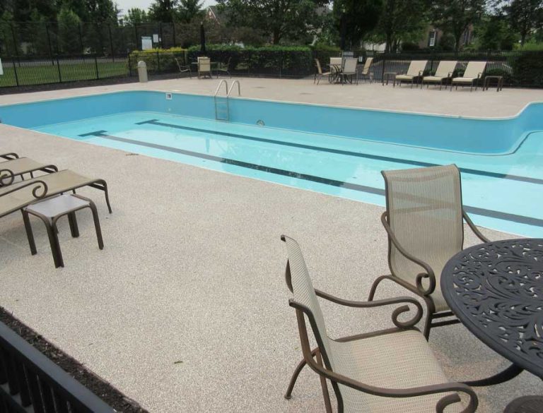 a pool with a graniflex concrete pool deck